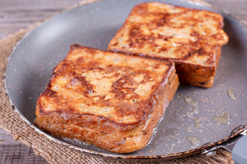 Photo of a grilled cheese sandwich cooking in a frying pan