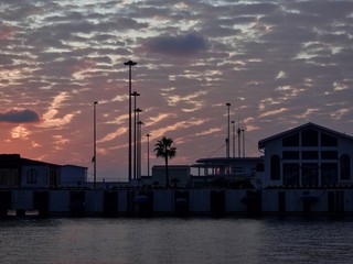 Fototapeta na wymiar Sunset, the new sea terminal, Russia, Sochi. Berth. Black Sea. Evening clouds.