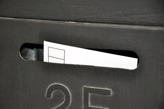 A letter in a black mailbox