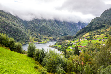 Steinsdalsfossen waterfall and meadow in the valley in Norway
