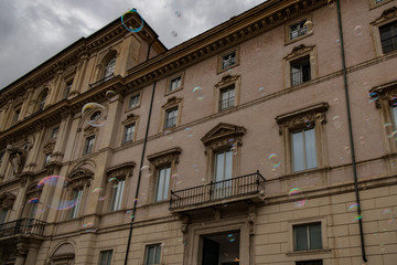 Soap bubbles with old building in background