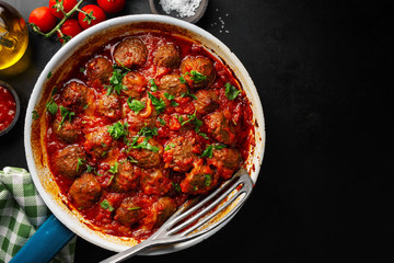Fried meatballs with sauce on pan