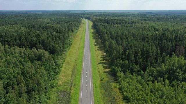 Aerial top view landscape with a country road in the forest at summer, 4k