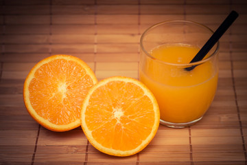 orange juice in glass on wooden table