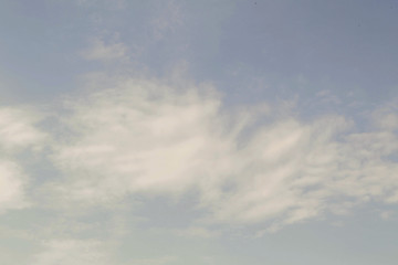 A piece of blue sky with highly layered clouds