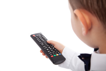 Little boy changing channels on TV using remote control, isolated on white. Empty space