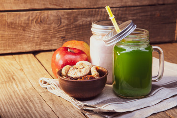 Green healthy smoothie in glass jar on rustik wood
