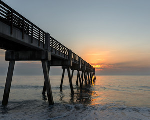 a pier at sunrise