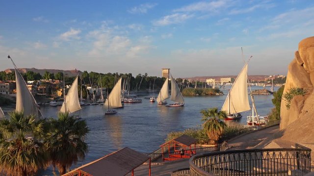 Beautiful landscape with felucca boats on Nile river in Aswan at sunset, Egypt, 4k