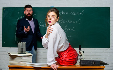 Attractive teacher in leather skirt. Cheeky teacher. Impudent student. Flirting with colleague....