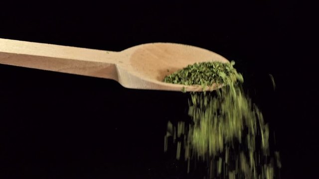 One spoon of corriander leaves. Spices and food ingredients.