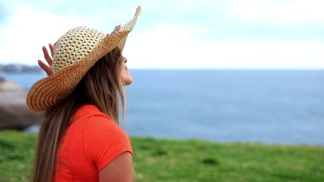 Beautiful young caucasian woman enjoying the outdoor leisure activity alone - girl have fun in the park - people with nature around - attractive trendy female with red shirt and white pants