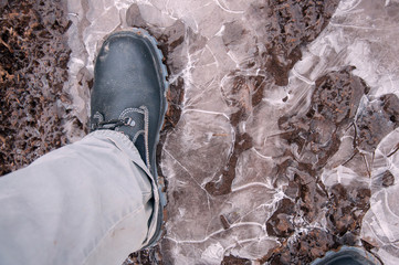 Work boots on a background of frozen ground. Work shoes