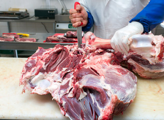 cutting meat in the meat shop