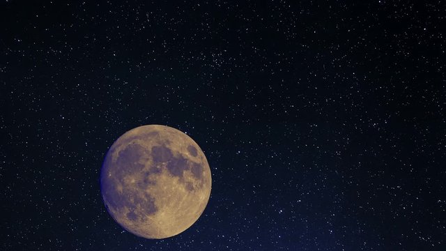 Blue moon rising on a starlit night