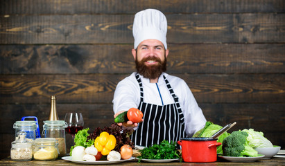 Man bearded hipster hat and apron cooking healthy food. Vegetarian lifestyle. Chef prepare...