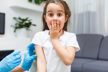 Doctor vaccinating little girl