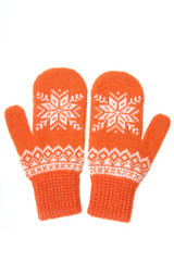 Warm woolen knitted mittens isolated on white background. Orange knitted mittens with pattern