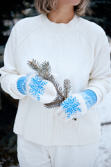 Hands in Knitted Mittens. Winter lifestyle. Wearing Stylish Warm Clothes. Woman in warm clothes