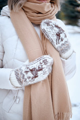 Hands in Knitted Mittens. Winter lifestyle. Wearing Stylish Warm Clothes. Woman in warm clothes