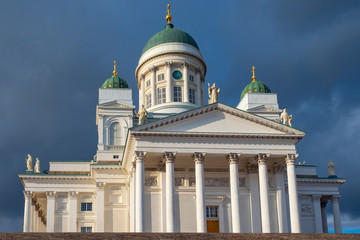Fototapeta na wymiar Helsinki. Finland. White Cathedral against the gray clouds. Suurkirkko. Cathedral Of St. Nicholas. Cathedrals Of Finland. Architecture of the capital of Finland. A journey through the Scandinavia.