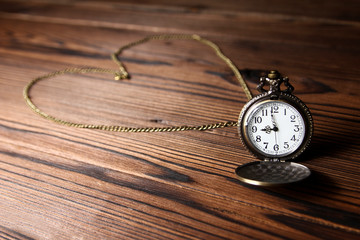 pocket watch on a wooden background
