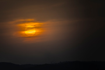 A vivid orange sunset caused by bushfire smoke in The Blue Mountains in Australia