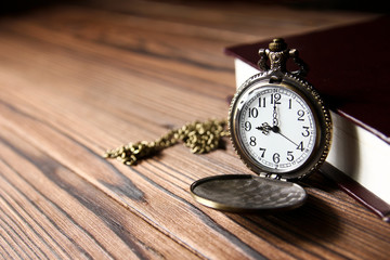 a pocket watch with book background