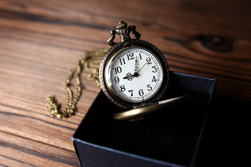 a pocket watch with book background