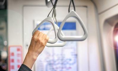 Woman's Hand Hold on to a Handle Bar on a Public Transportation while Standing.