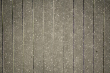 A view of snow falling against the black fence.