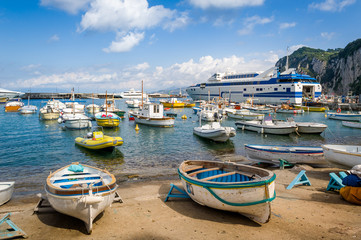 Fototapeta na wymiar Marina di Capri harbor with fisherman's boats and cruising vessels. Amalfi coast, Italy.