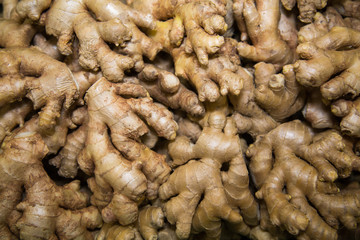 Fresh yellow ginger roots in a plastic box. Vegetables, fruits, useful products.
