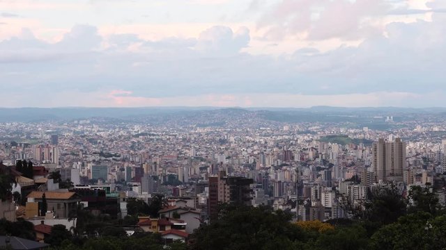 Sunset motion time lapse of cityscape with high rise buildings and skyscrapers of Belo Horizonte, capital of the state Minas Gerais in Brazil seen from the hills surrounding the urban conglomerate