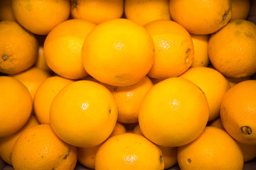 Yellow oranges in bulk. Fruits, citrus fruits, useful products.