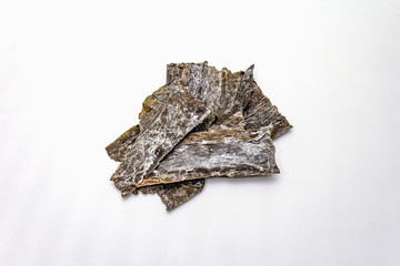 Dry laminaria japonica（kelp）Isolated on white background. Kombu seaweed, traditional Japanese ingredient for cooking Dashi soup.