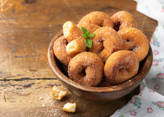 Homemade rosquillas, traditional anise donuts from Spain, typically eaten in Easter, on a rustic wooden table, copyspace. Still life.