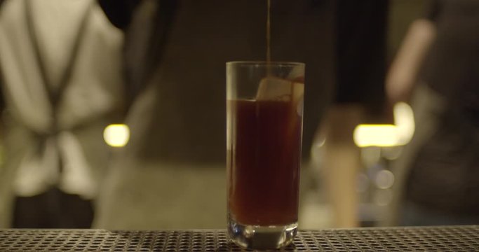 Bartender making cocktails on the bar table. barman shaking cocktails in the bar. Process of making cocktails in the modern restaurant bar