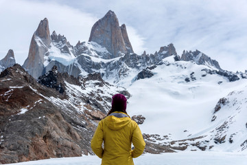 Fototapeta na wymiar A hiker with a yellow jacket on the base of Fitz Roy Mountain in Patagonia, Argentina