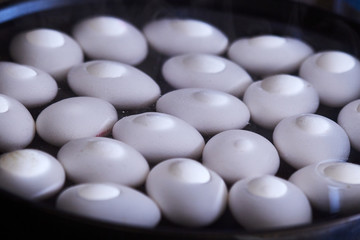 Fototapeta na wymiar White eggs are boiled in water for Easter