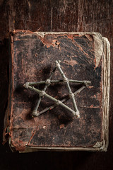 Old book with a pentagram made of sticks