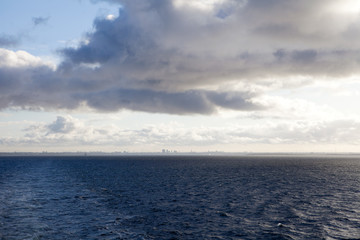 Blue sky with clouds and sun reflection in water with place for your text. anazing clouds, mist in the sky