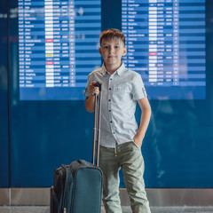 Selfsufficient and selfresponsibility concept. Stylish European boy in front of departure board at airport, he going to spend his holidays abroad. - 316277513
