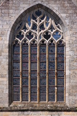 Pointed window with gothic tracery at Saint Sauveur basilica in Dinan city, Brittany in France