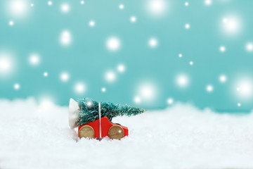 Fototapeta na wymiar Christmas tree on a toy car