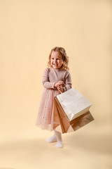 Small fashion girl . happy shopping girl runs with full bags and laughs. black Friday discount. cyber Monday. Present and gifts buy. summer sales. copy space.
