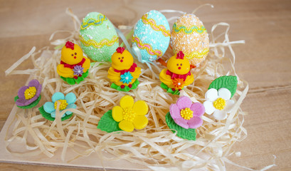 Easter eggs on wooden background. Easter chickens on beautiful spring flowers easter eggs copyspace.