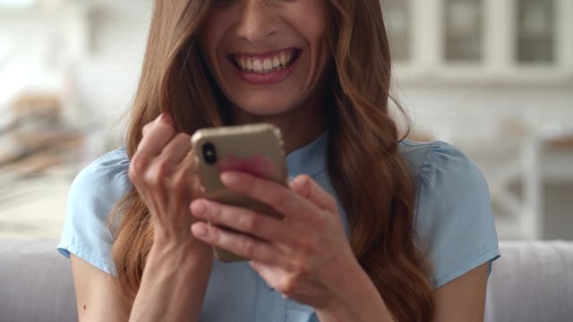 Excited business woman feeling happy at remote office. Girl with mobile phone