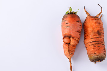Ugly organic carrot on white background. Concept environmental shopping, Copy space