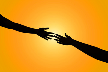 Silhouette of helping hand between two climber